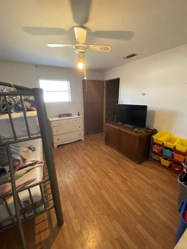 bedroom with ceiling fan and light hardwood / wood-style floors