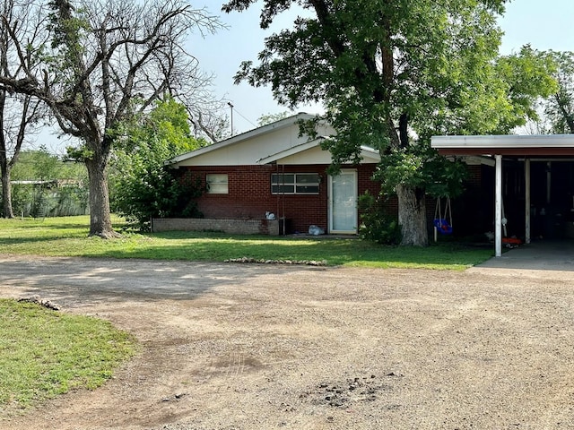 view of home's exterior featuring a carport and a yard