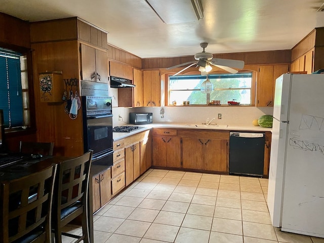 kitchen with sink, light tile patterned floors, ceiling fan, and black appliances