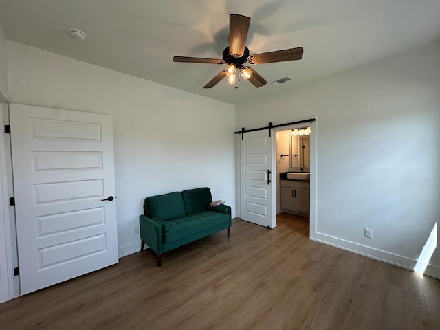 3615 Clearview Dr, San Angelo, TX 76904 - living area with wood finished floors, a barn door, and a ceiling fan