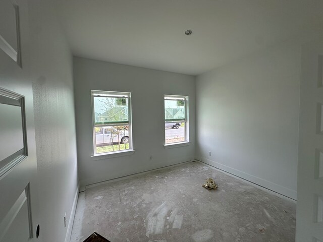 spare room featuring baseboards