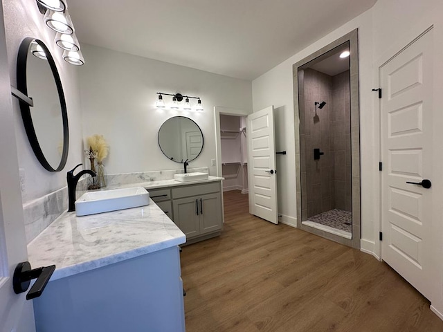 3615 Clearview Dr, San Angelo, TX 76904 - full bath with a shower stall, vanity, wood finished floors, and a walk in closet