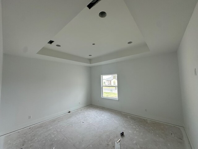 spare room with a tray ceiling