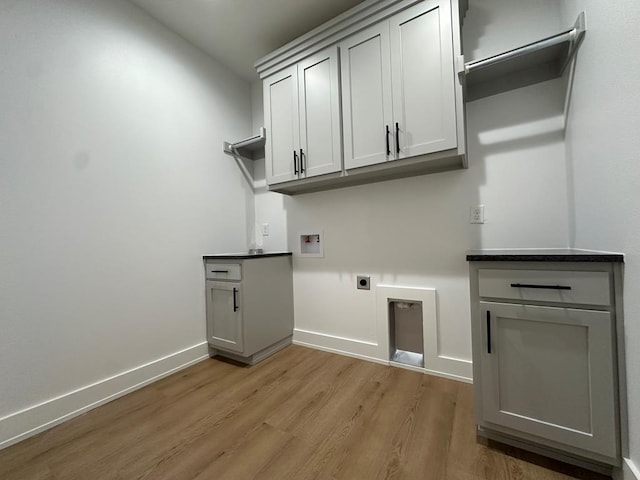 3615 Clearview Dr, San Angelo, TX 76904 - laundry area with cabinet space, washer hookup, light wood-type flooring, and electric dryer hookup