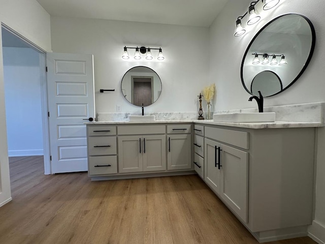 3615 Clearview Dr, San Angelo, TX 76904 - full bath featuring wood finished floors and double vanity