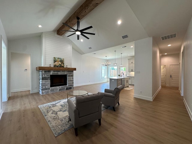 3615 Clearview Dr, San Angelo, TX 76904 - living room with ceiling fan, a fireplace, light wood-type flooring, and recessed lighting