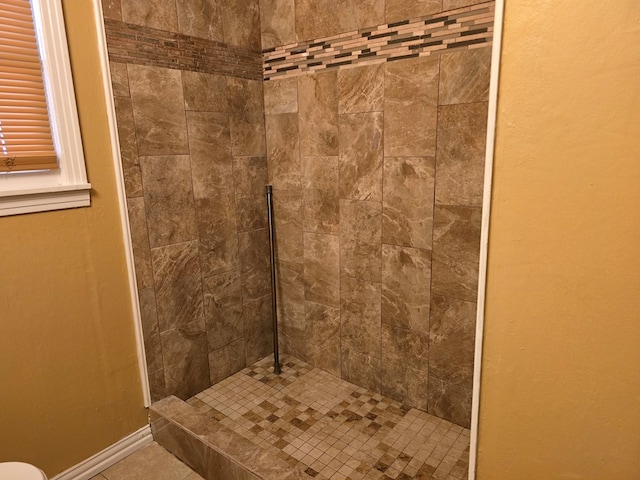 42 W 26th St, San Angelo, TX 76903 - bathroom featuring tiled shower and tile patterned floors