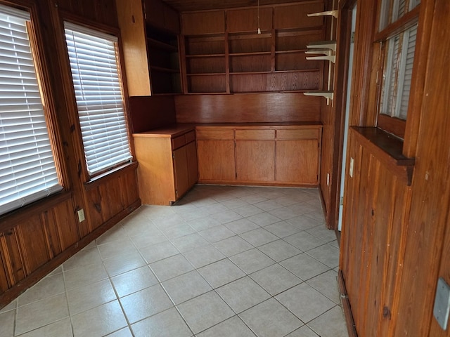 42 W 26th St, San Angelo, TX 76903 - unfurnished office featuring wood walls, light tile patterned flooring, and built in shelves