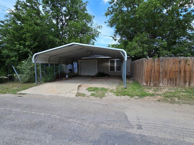 42 W 26th St, San Angelo, TX 76903 - view of car parking featuring a garage, a carport, and driveway