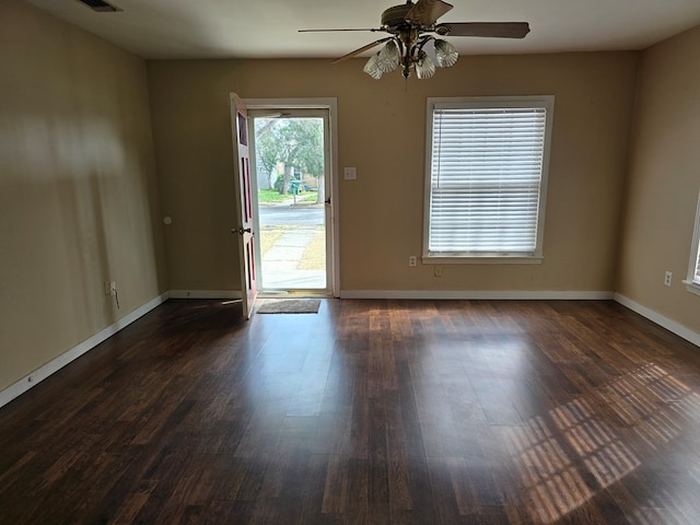 42 W 26th St, San Angelo, TX 76903 - spare room featuring ceiling fan, dark wood-type flooring, and baseboards