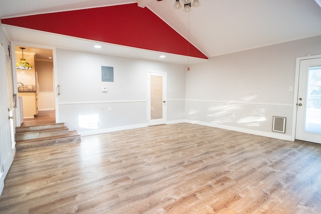 unfurnished living room featuring wood-type flooring and high vaulted ceiling