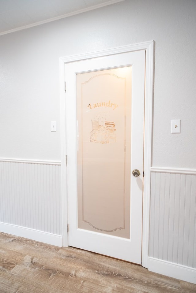 room details with crown molding and hardwood / wood-style flooring