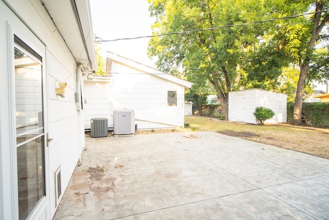 view of patio / terrace featuring central air condition unit and a storage unit