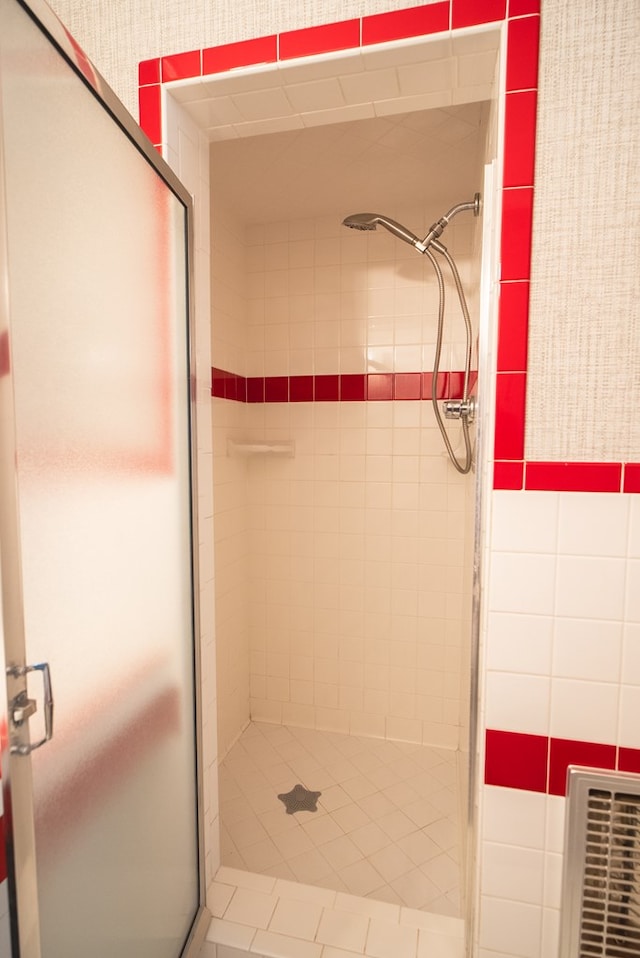 bathroom featuring a shower with shower door