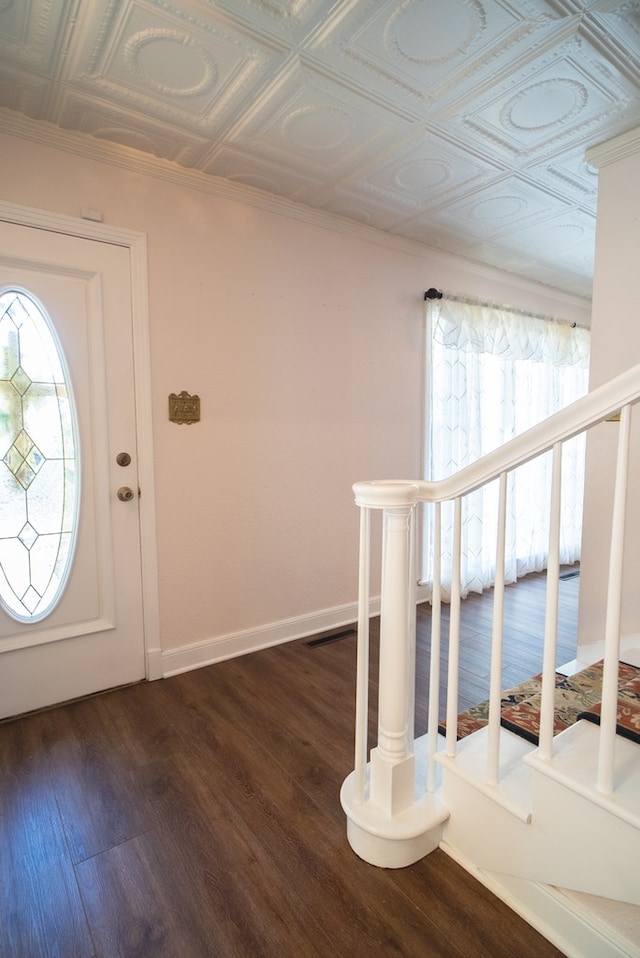 foyer featuring dark wood-type flooring and a wealth of natural light