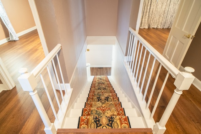 staircase featuring hardwood / wood-style flooring