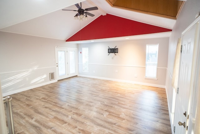 unfurnished living room with vaulted ceiling with beams, ceiling fan, and light hardwood / wood-style flooring