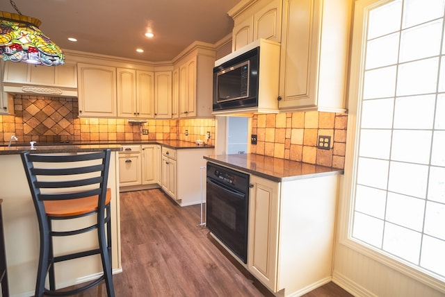 kitchen featuring dark hardwood / wood-style floors, built in microwave, oven, dark stone counters, and decorative backsplash