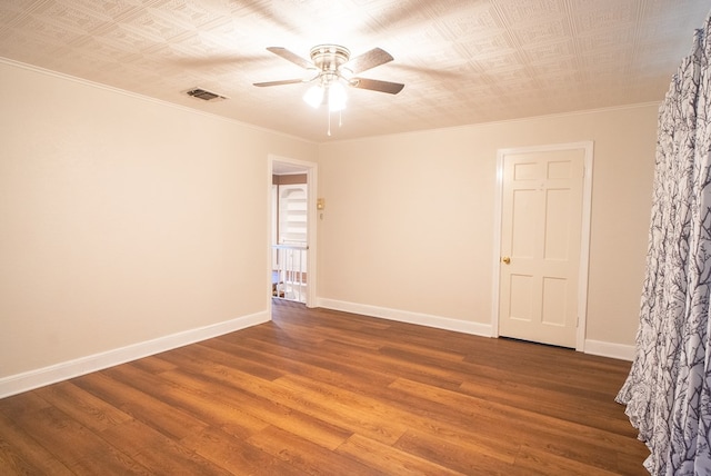 spare room featuring hardwood / wood-style floors, ornamental molding, and ceiling fan