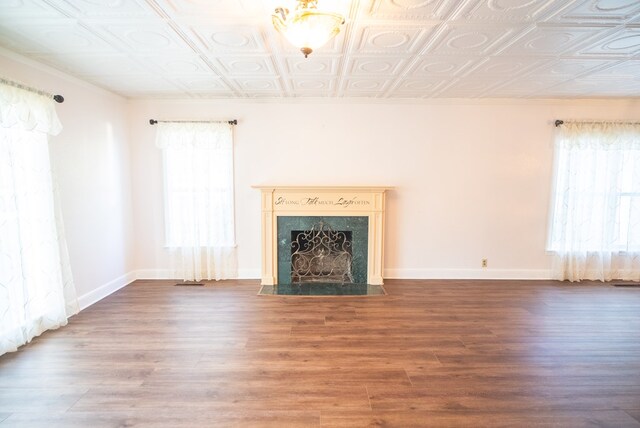 unfurnished living room with hardwood / wood-style flooring and a fireplace