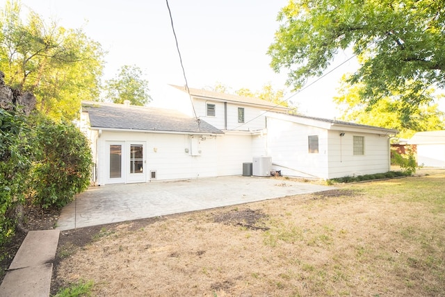 back of property with a yard, central AC, and a patio