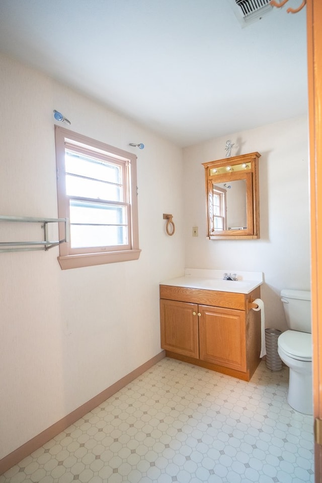 bathroom with vanity and toilet