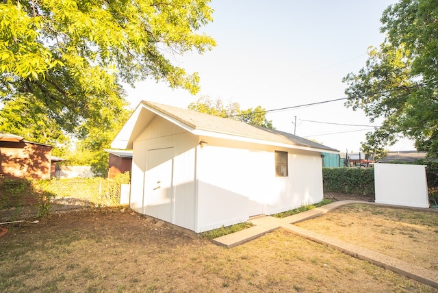 view of property exterior with a storage unit and a yard