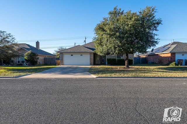 single story home with a garage and a front yard