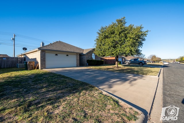 ranch-style house with a front yard and central air condition unit