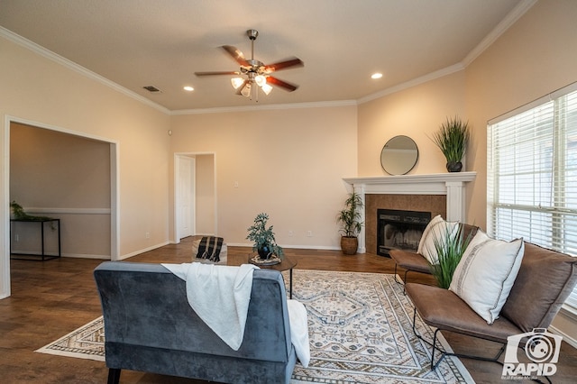 living room with dark wood-type flooring, ceiling fan, and crown molding