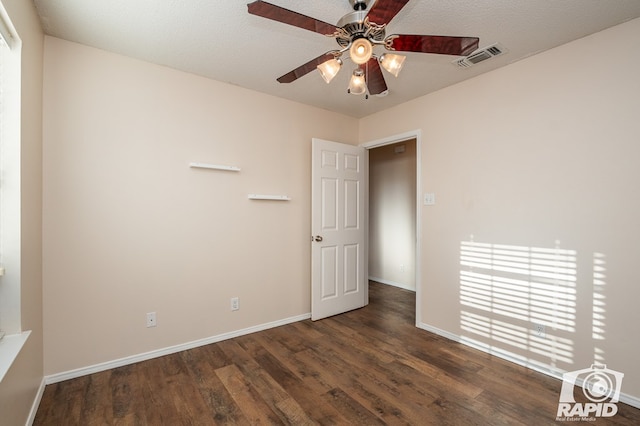 unfurnished room featuring dark hardwood / wood-style flooring, a textured ceiling, and ceiling fan