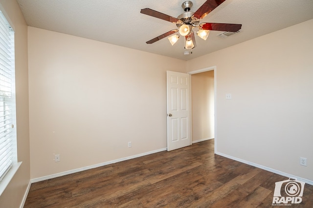 spare room with dark hardwood / wood-style flooring, plenty of natural light, and ceiling fan