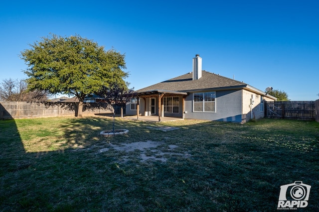 rear view of property with a patio and a yard