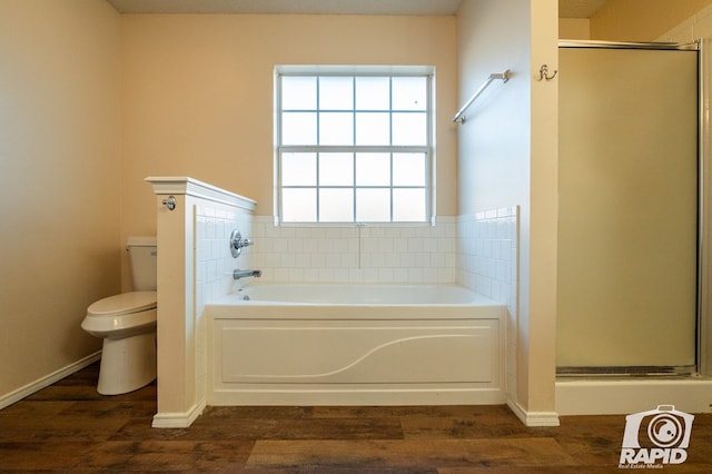 bathroom with hardwood / wood-style flooring, toilet, and separate shower and tub