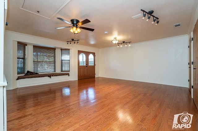 entryway with ceiling fan, ornamental molding, and light hardwood / wood-style floors