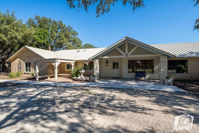 single story home featuring a pergola and a patio