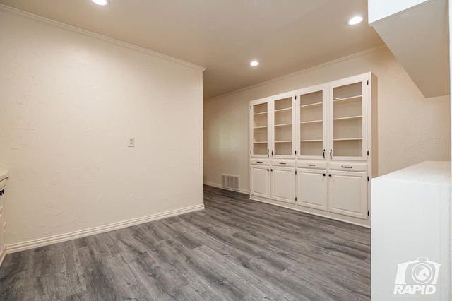 empty room featuring ornamental molding and dark hardwood / wood-style floors