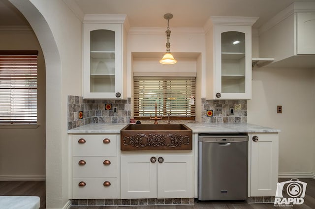 kitchen featuring light stone counters, sink, stainless steel dishwasher, and white cabinets