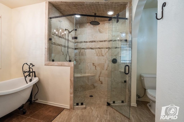 bathroom featuring tile patterned flooring, plus walk in shower, and toilet