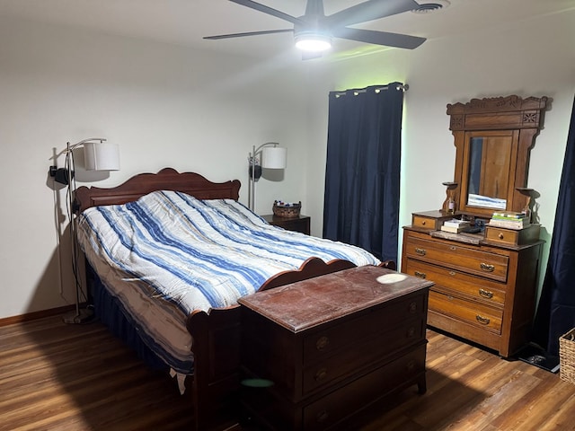 bedroom featuring baseboards, ceiling fan, and wood finished floors