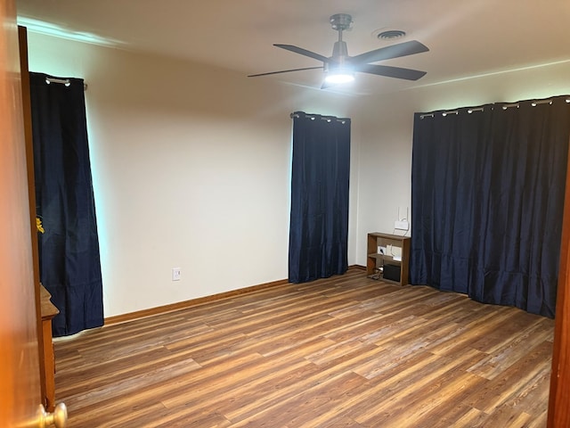 spare room with a ceiling fan and wood finished floors