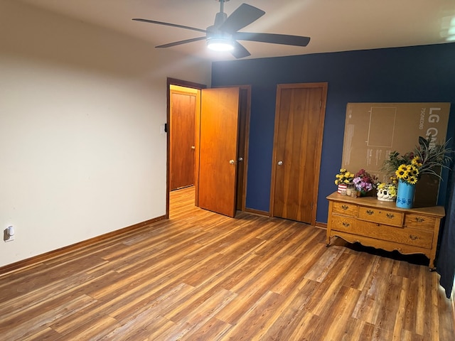 bedroom featuring baseboards, a ceiling fan, and wood finished floors