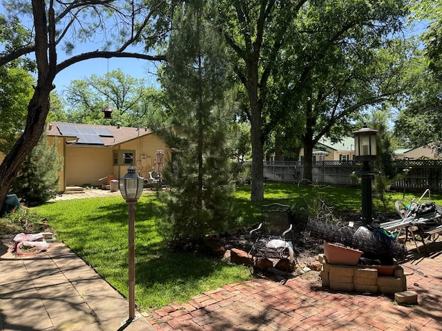 view of yard featuring fence and a patio area