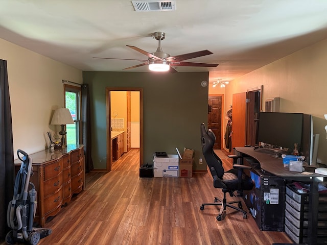 office space with visible vents, ceiling fan, and wood finished floors
