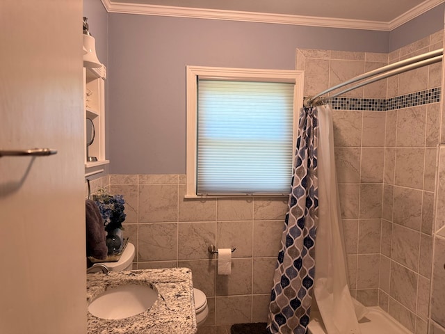 full bath featuring a sink, a stall shower, toilet, and tile walls