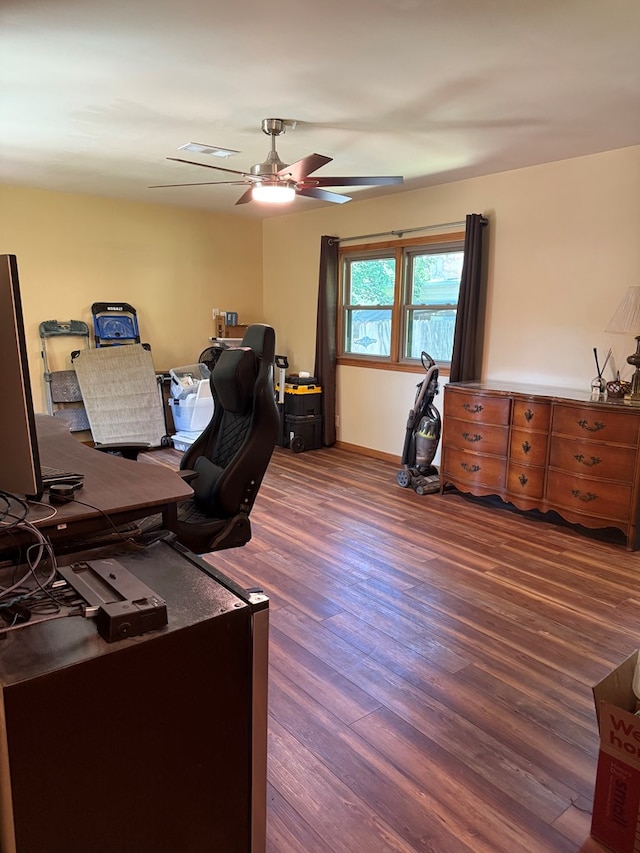 office with baseboards, ceiling fan, visible vents, and wood finished floors