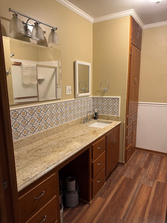 bathroom featuring crown molding, wood finished floors, and vanity