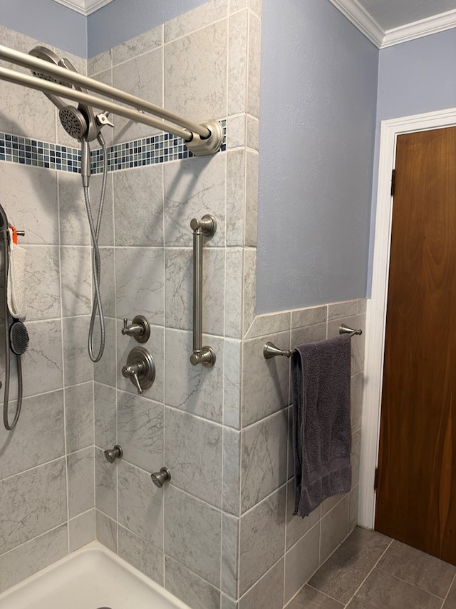 full bath with crown molding and a tile shower