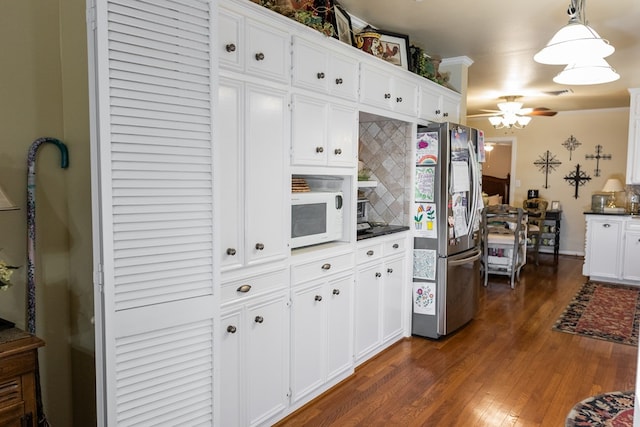 kitchen with white cabinetry, hanging light fixtures, stainless steel fridge, ceiling fan, and dark wood-type flooring