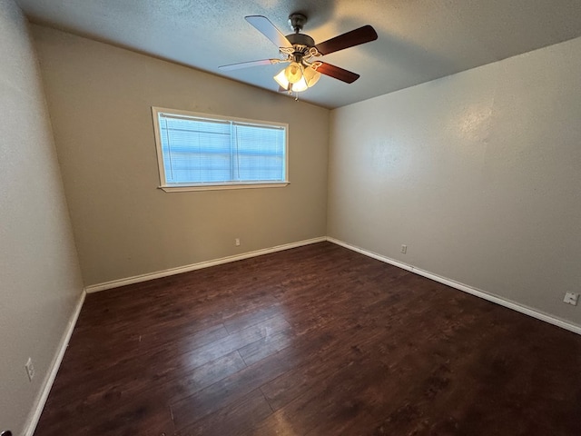 spare room featuring ceiling fan and dark hardwood / wood-style floors